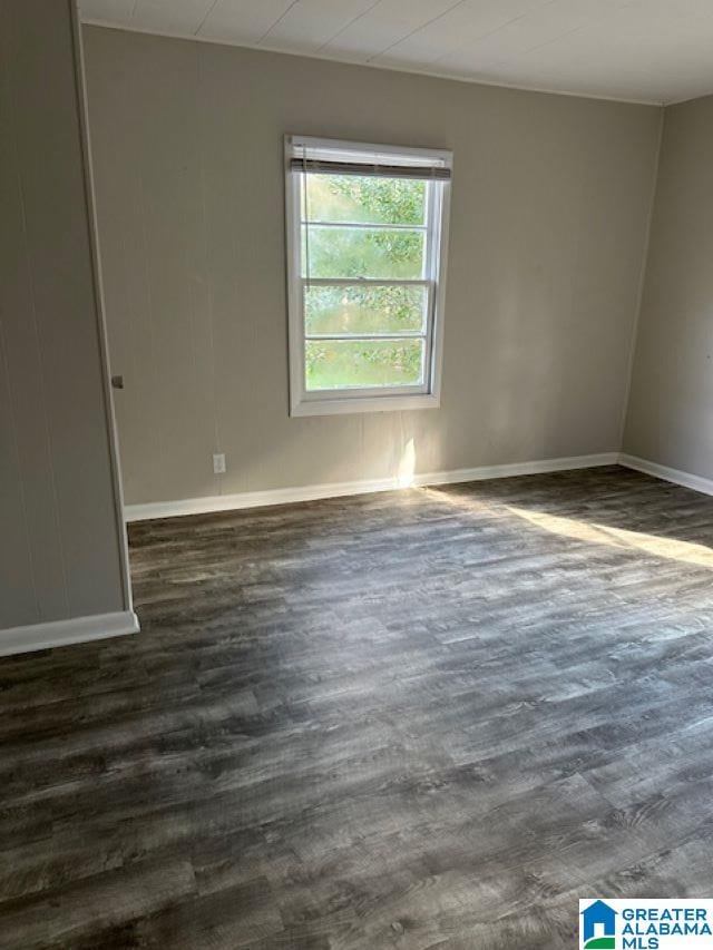 unfurnished room with dark hardwood / wood-style floors