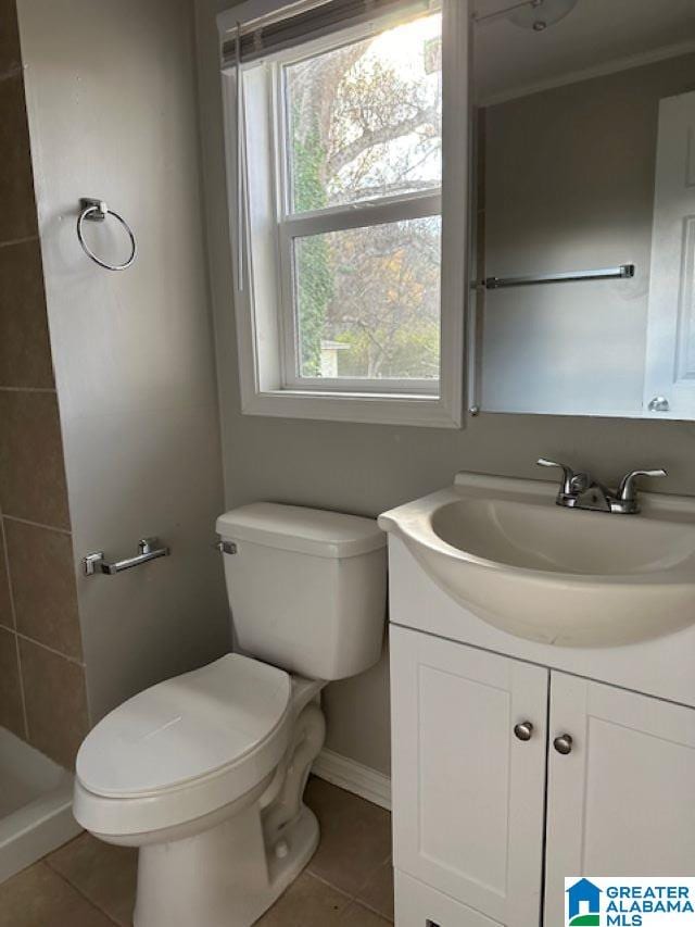 bathroom with tile patterned floors, a shower, vanity, and toilet