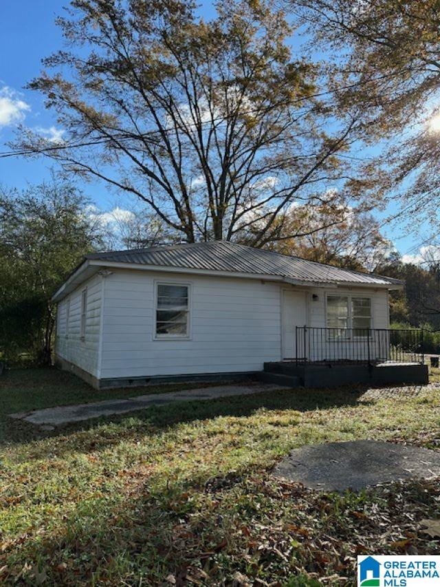 view of home's exterior with a yard and a deck