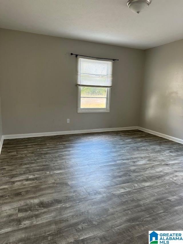 spare room featuring dark wood-type flooring