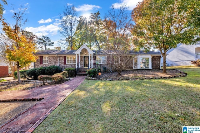 ranch-style home featuring a front yard