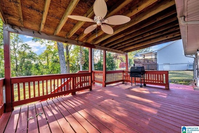 deck featuring ceiling fan and a grill