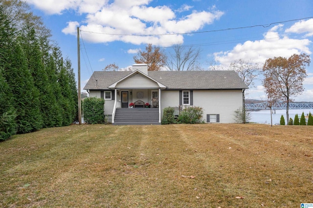 view of front of house with a water view, a front lawn, and covered porch