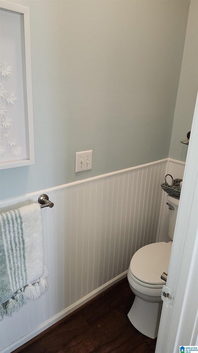 bathroom featuring hardwood / wood-style flooring and toilet