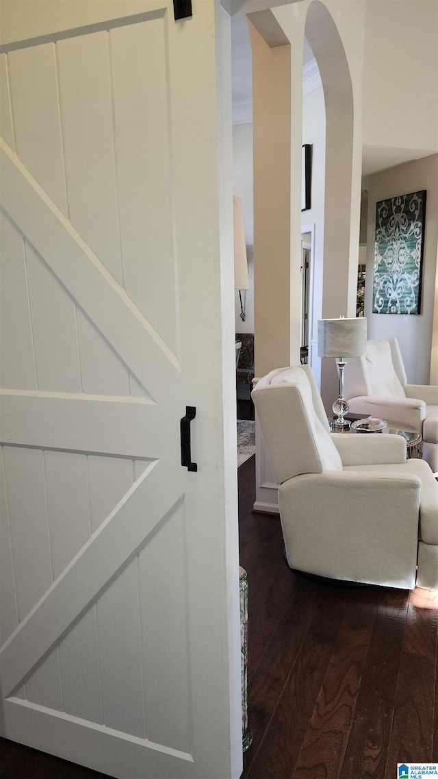 interior space with ornamental molding and hardwood / wood-style flooring