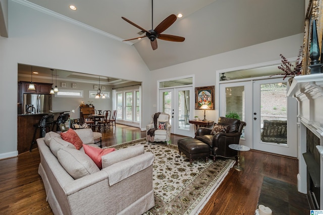 living room featuring dark wood-type flooring, high vaulted ceiling, french doors, crown molding, and ceiling fan