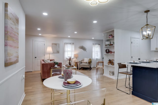 living room featuring light wood-type flooring and a chandelier