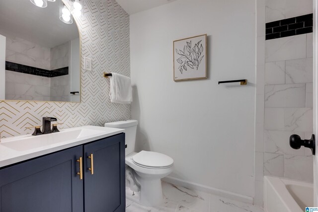 full bathroom featuring vanity, toilet, and tiled shower / bath