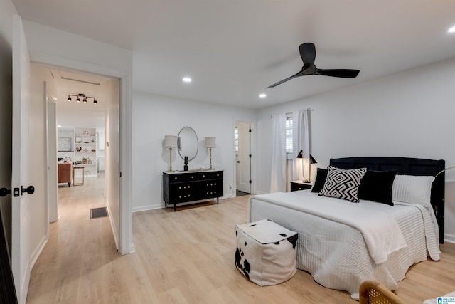 bedroom with ceiling fan and light hardwood / wood-style floors