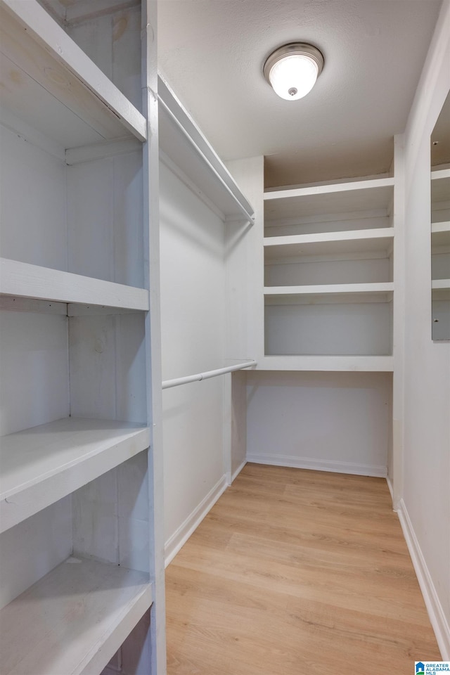 spacious closet featuring hardwood / wood-style flooring