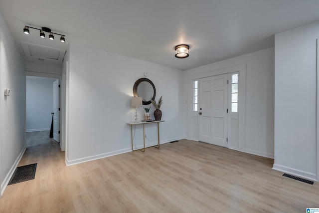 foyer featuring light hardwood / wood-style floors and track lighting