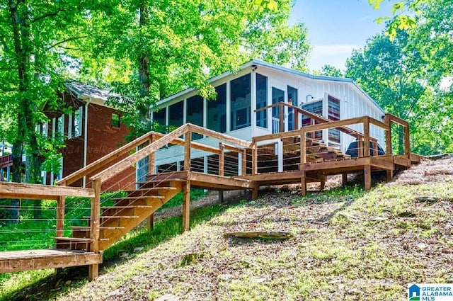 back of house featuring a sunroom