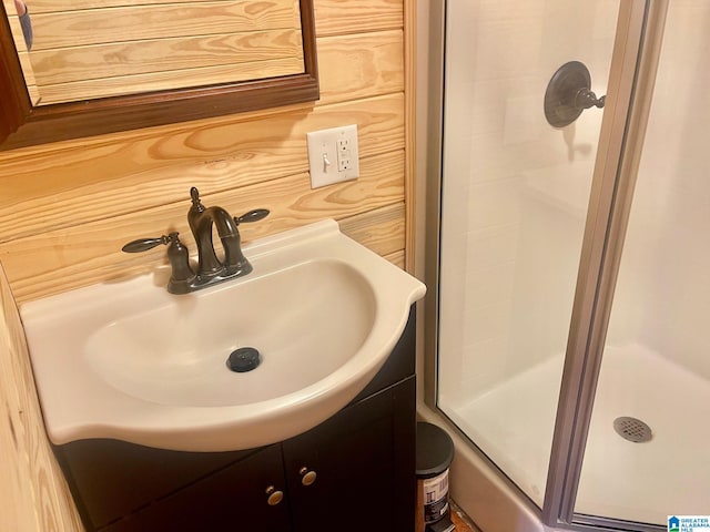 bathroom with vanity and a shower with shower door