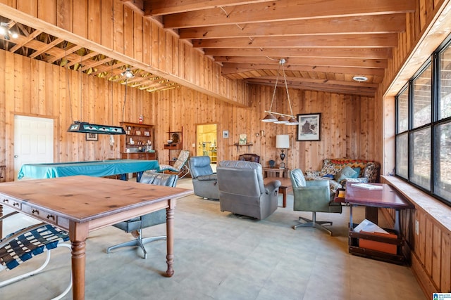 rec room with lofted ceiling with beams and wood walls