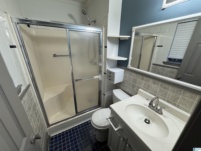 bathroom with tile patterned floors, an enclosed shower, ornamental molding, vanity, and toilet