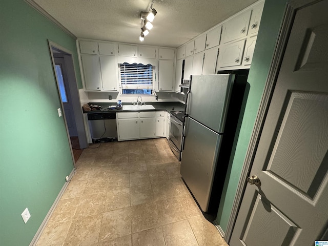 kitchen with sink, white cabinets, stainless steel appliances, and a textured ceiling