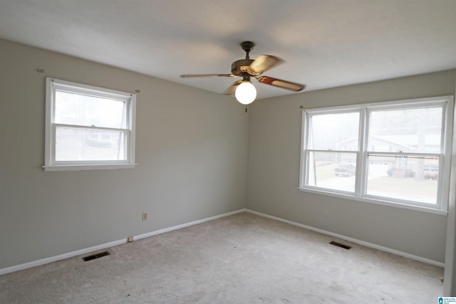 spare room featuring ceiling fan and light colored carpet