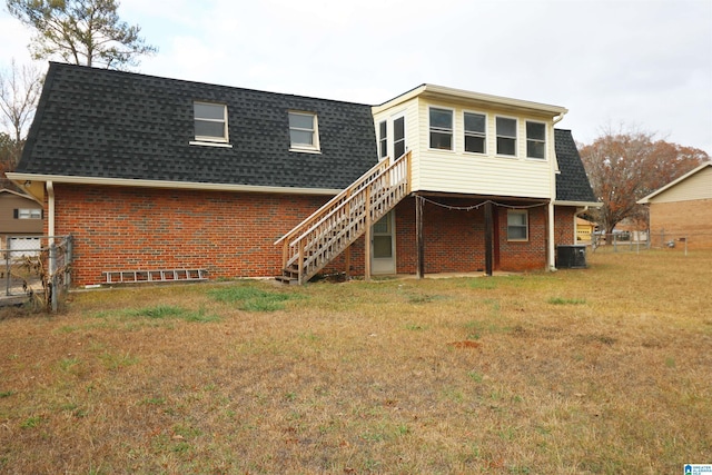 back of property featuring a yard and central AC unit