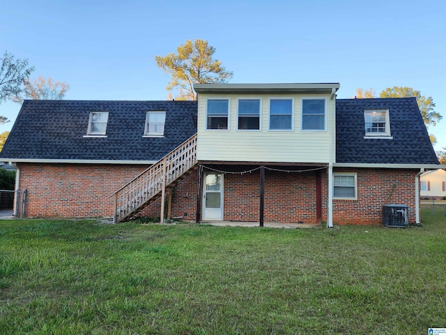 back of house with a lawn and central air condition unit