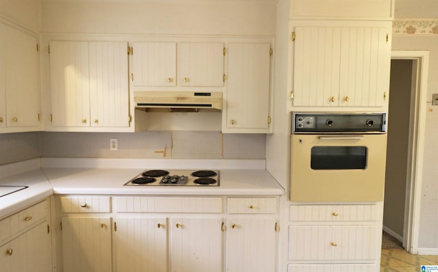 kitchen featuring tasteful backsplash and white appliances