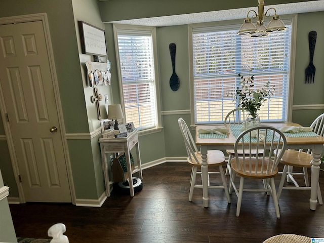 dining area featuring dark hardwood / wood-style floors and a notable chandelier