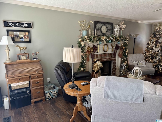 living room featuring a fireplace, dark hardwood / wood-style flooring, ornamental molding, and a textured ceiling