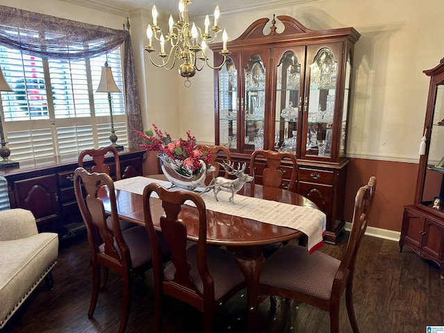 dining area with dark hardwood / wood-style floors, crown molding, and an inviting chandelier