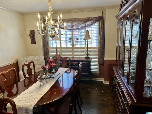 dining area with ornamental molding, dark wood-type flooring, and a notable chandelier