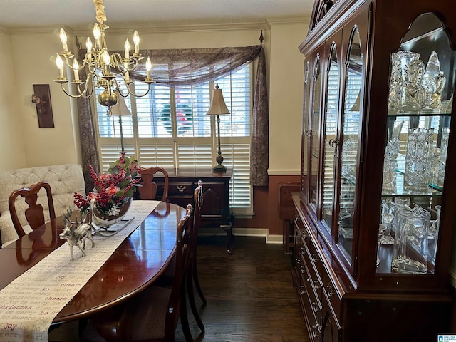 dining space featuring crown molding, dark wood-type flooring, and an inviting chandelier