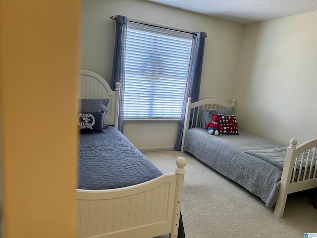 carpeted bedroom with a textured ceiling