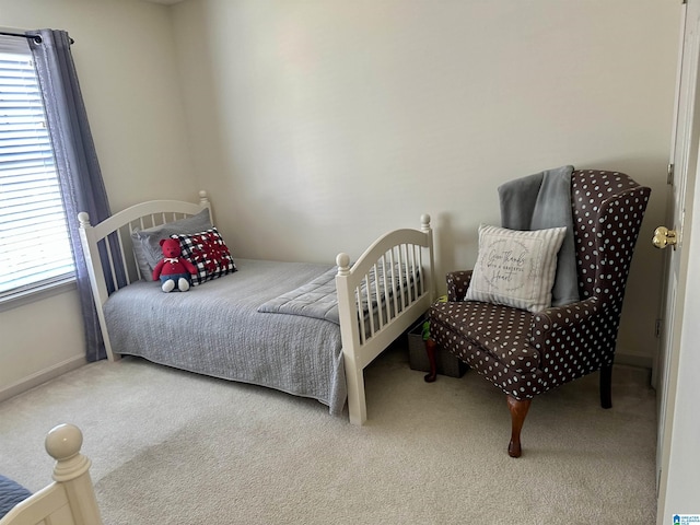 bedroom with multiple windows and carpet