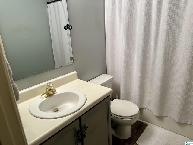 full bathroom featuring hardwood / wood-style flooring, vanity, toilet, and shower / tub combo