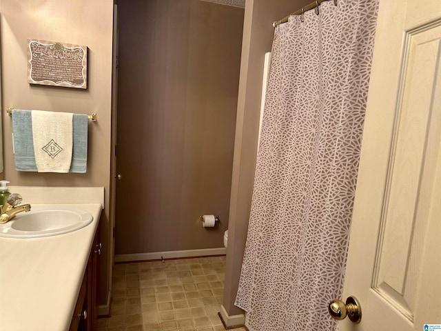 bathroom with vanity, a textured ceiling, and toilet