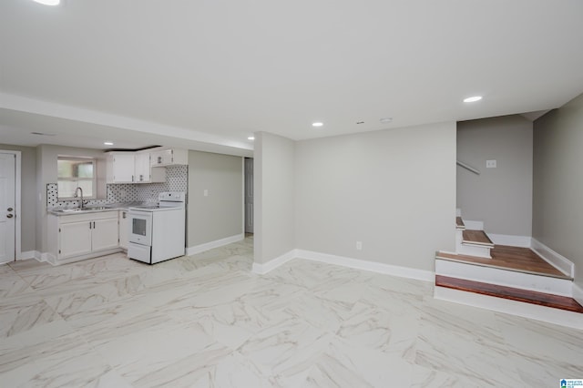 kitchen with backsplash, white cabinetry, white electric range, and sink