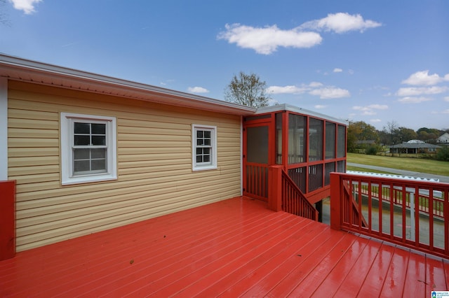 wooden deck featuring a sunroom