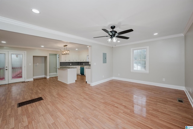 unfurnished living room featuring ceiling fan with notable chandelier, light wood-type flooring, crown molding, and electric panel