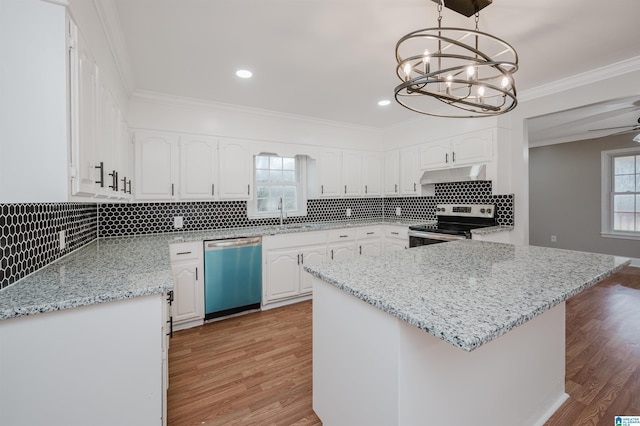 kitchen with white cabinetry, light hardwood / wood-style flooring, decorative light fixtures, ceiling fan with notable chandelier, and appliances with stainless steel finishes