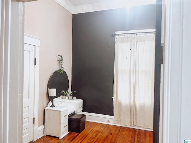 interior space with light hardwood / wood-style flooring and ornamental molding