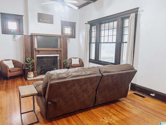 living room featuring ceiling fan and wood-type flooring