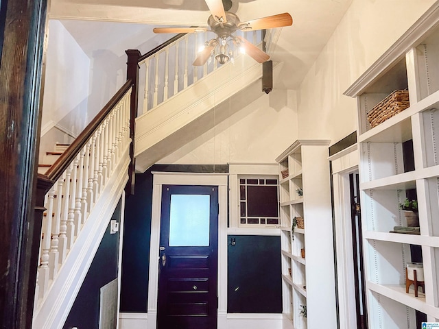 stairs featuring ceiling fan