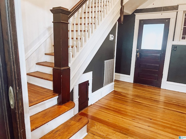 stairway with hardwood / wood-style flooring