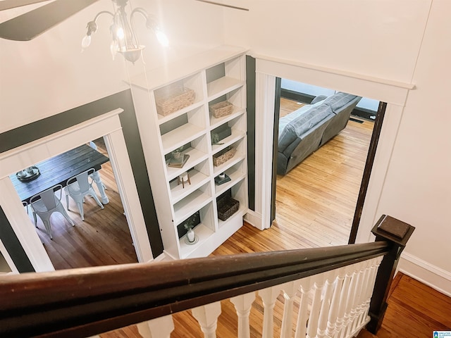 interior space featuring hardwood / wood-style flooring and a notable chandelier