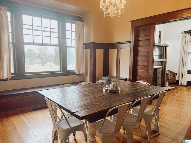 dining area with a notable chandelier and light hardwood / wood-style flooring