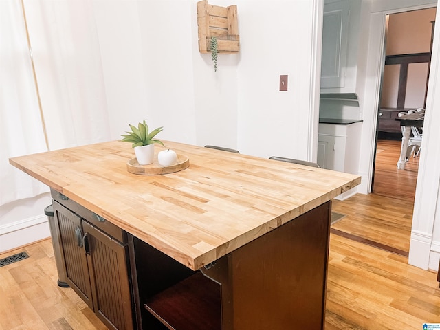 kitchen with dark brown cabinets and light wood-type flooring