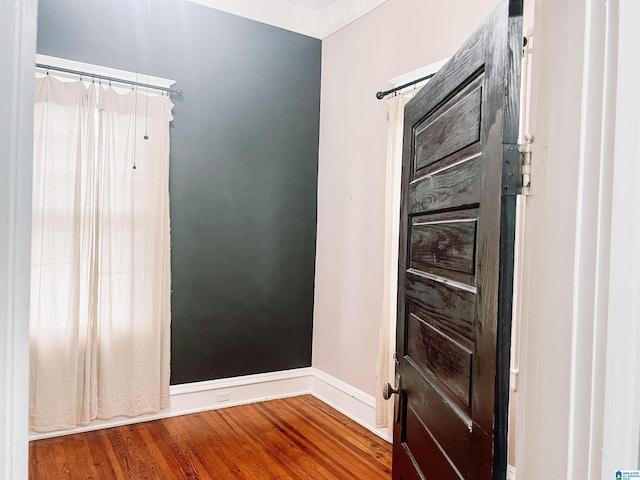 unfurnished room with hardwood / wood-style flooring and ornamental molding