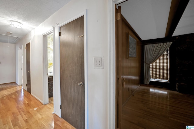 hall featuring hardwood / wood-style floors and a textured ceiling