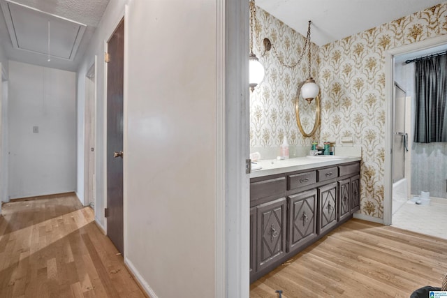 bathroom featuring shower / bathing tub combination, a textured ceiling, vanity, and hardwood / wood-style flooring