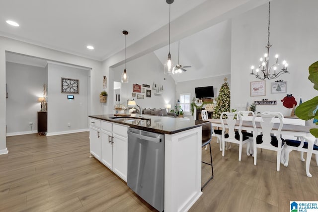 kitchen with sink, white cabinets, stainless steel dishwasher, and light hardwood / wood-style floors