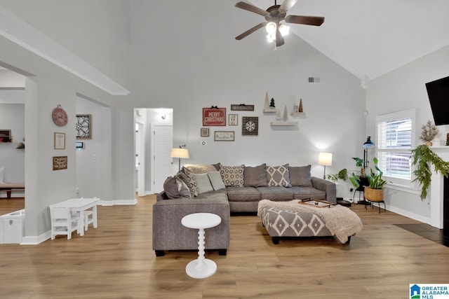 living room with high vaulted ceiling, light hardwood / wood-style flooring, and ceiling fan