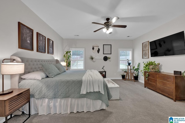 bedroom featuring carpet floors, multiple windows, and ceiling fan